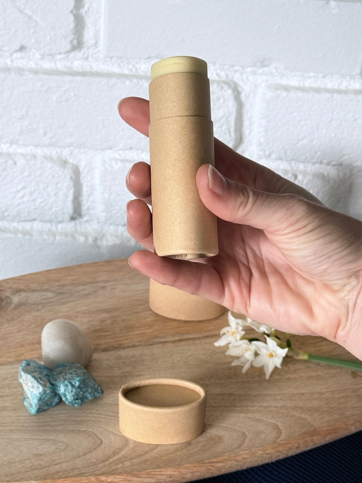 Hand holding a vegan magnesium deodorant stick, gentle natural deodorant small production, made in California
