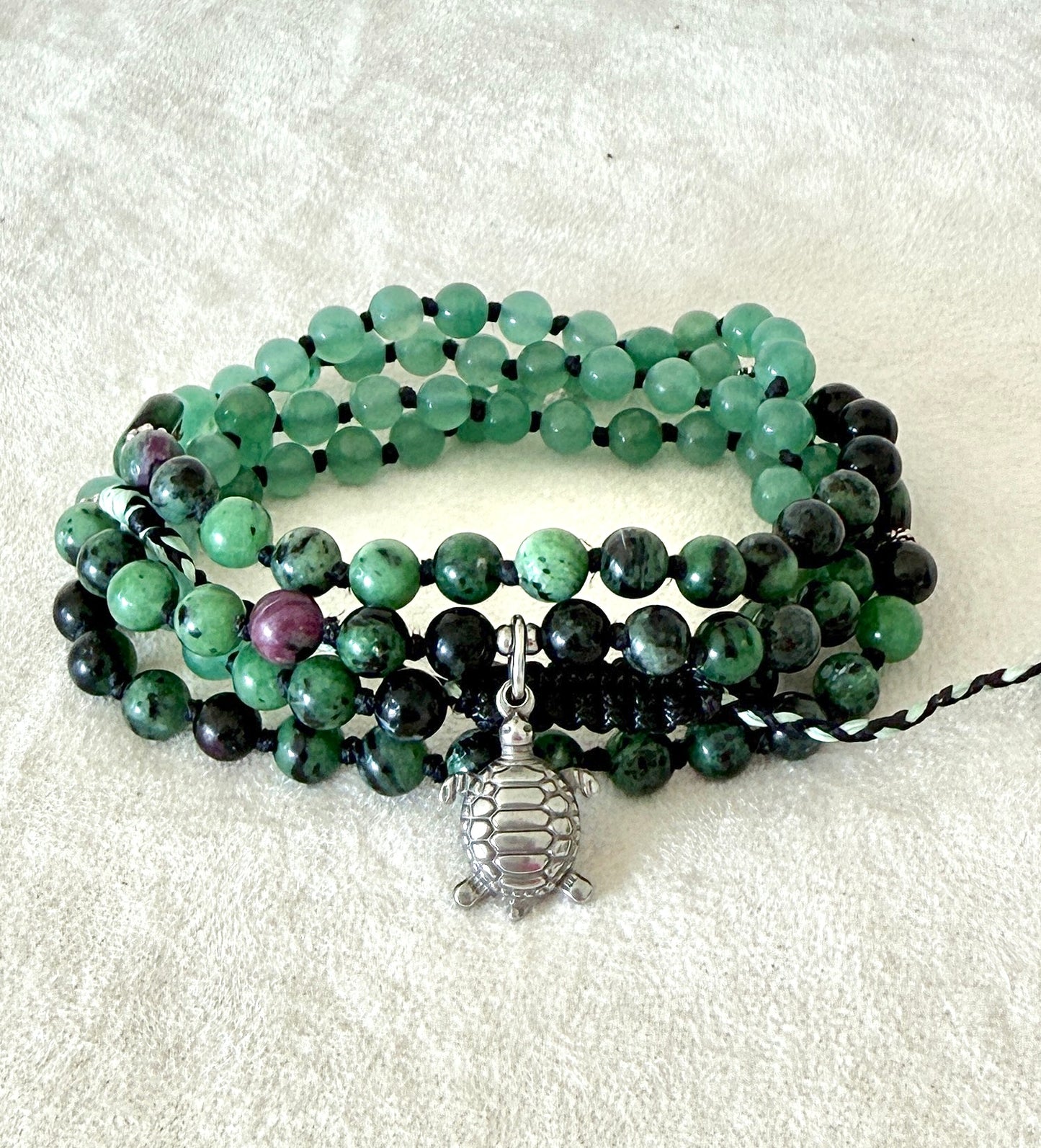 Handmade green mala bracelet with natural 6 mm gemstones, stainless steel turtle charm, adjustable macramé closure, and 108 bead mala necklace design for yoga, meditation, gentle growth, protection, and spiritual transformation. 