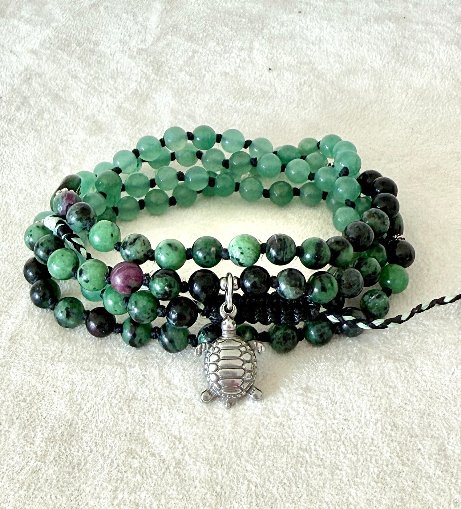 Handmade green mala bracelet with natural 6 mm gemstones, stainless steel turtle charm, adjustable macramé closure, and 108 bead mala necklace design for yoga, meditation, gentle growth, protection, and spiritual transformation. 