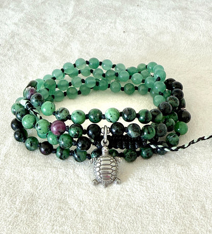 Handmade green mala bracelet with natural 6 mm gemstones, stainless steel turtle charm, adjustable macramé closure, and 108 bead mala necklace design for yoga, meditation, gentle growth, protection, and spiritual transformation. 