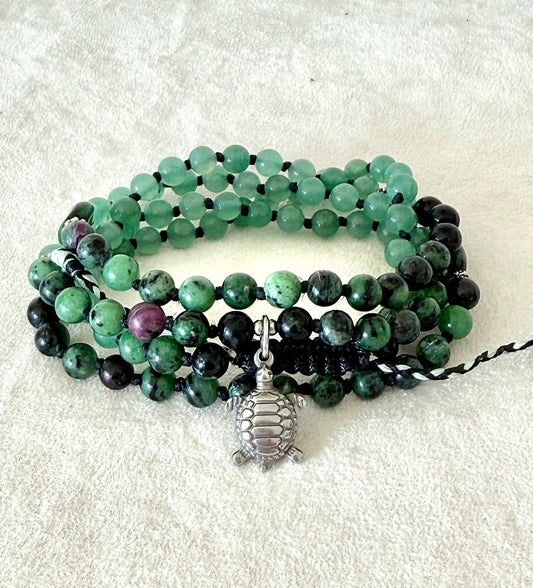 Handmade green mala bracelet with natural 6 mm gemstones, stainless steel turtle charm, adjustable macramé closure, and 108 bead mala necklace design for yoga, meditation, gentle growth, protection, and spiritual transformation. 