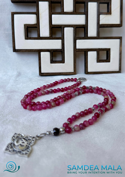 Mala necklace in watermelon tourmaline for heart chakra healing. Heart chakra mala beads necklace with OM and lotus charm. Mala for Meditation for women with watermelon tourmaline and garnet for heart protection and clarity with Anahata chakra pendant.