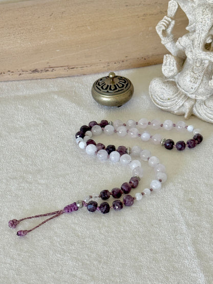 Pause Breathing Mala extended to show the full strand of garnet, clear quartz, and rose quartz beads