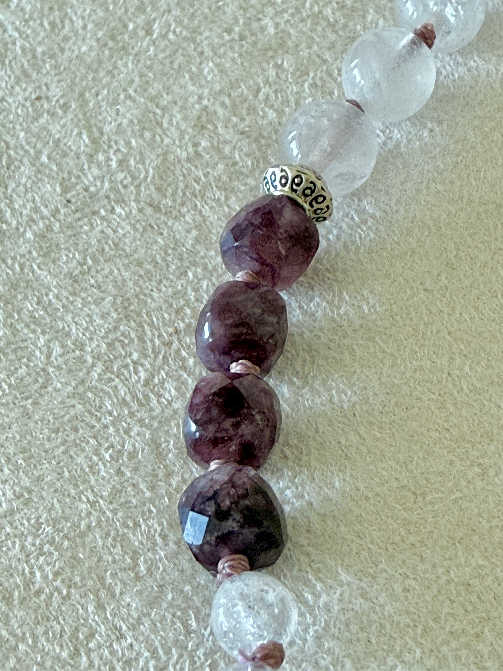 Close-up of garnet, clear quartz, and rose quartz beads on the Pause Breathing half mala bracelet