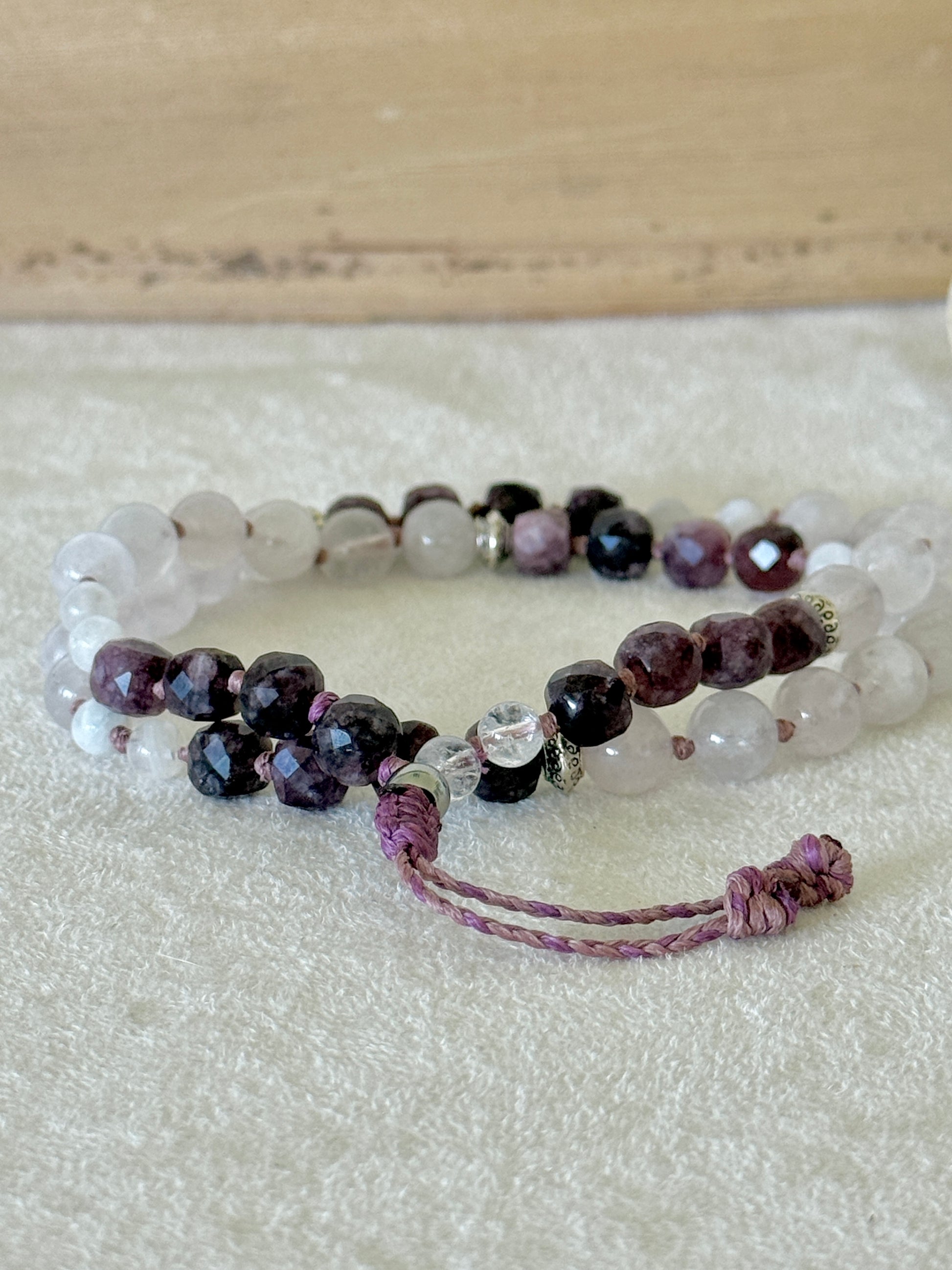 Pause Breathing Mala worn as a wrap bracelet on the wrist, with garnet, clear quartz, and rose quartz beads – Samdea Mala