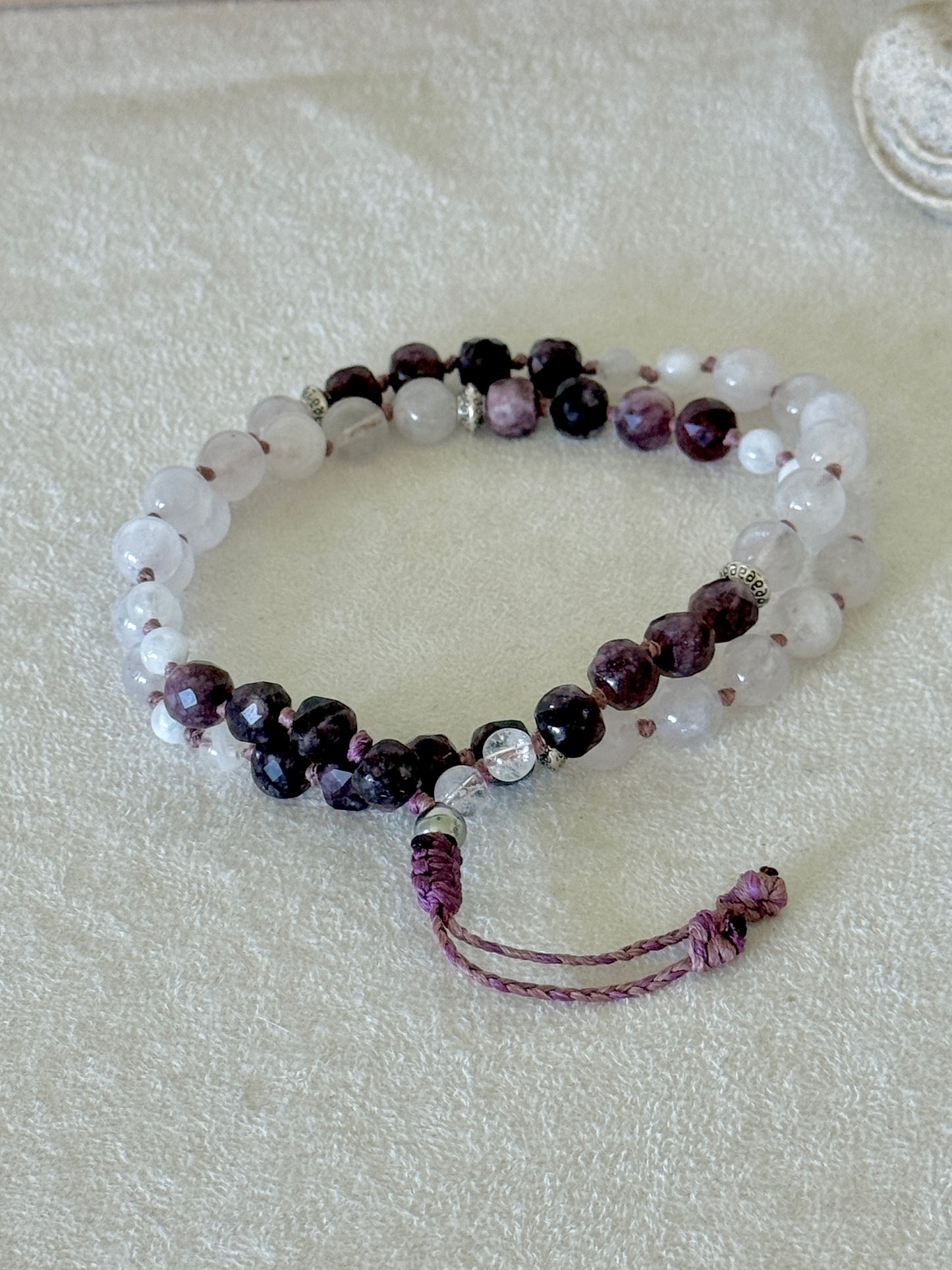Pause Breathing Mala bracelet with garnet, clear quartz, and rose quartz beads and adjustable cord closure