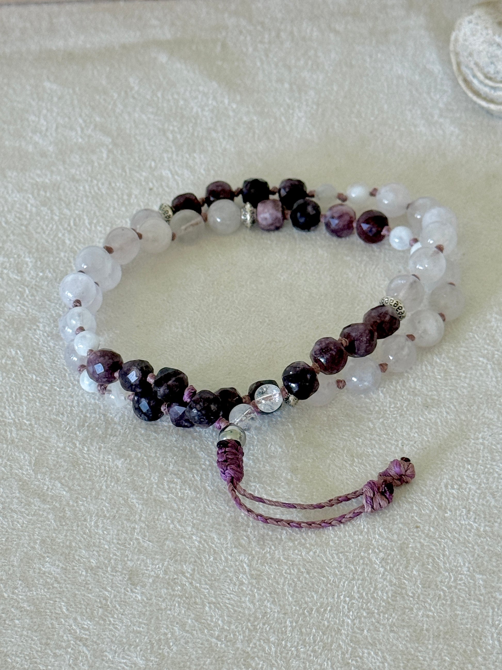 Pause Breathing Mala bracelet with garnet, clear quartz, and rose quartz beads and adjustable cord closure