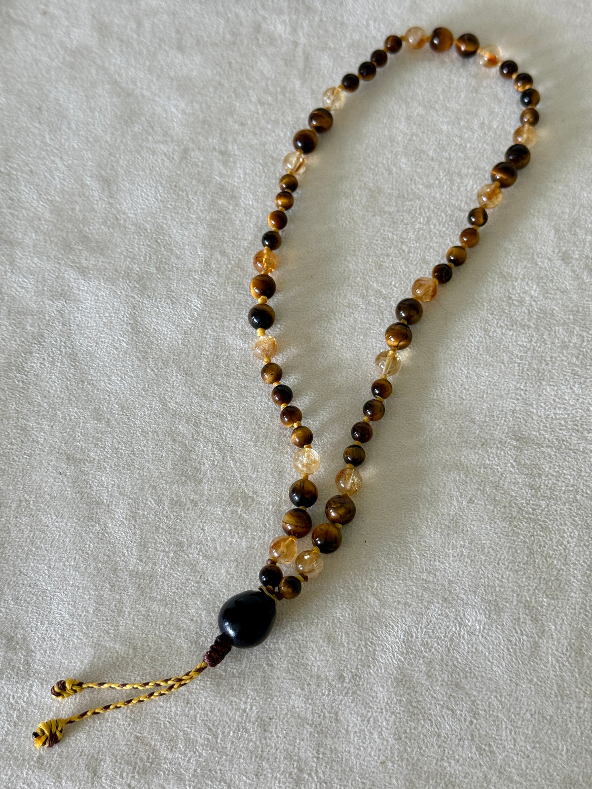 Handmade Box Breathing Mala with tiger's eye and citrine, featuring a natural soap-berry seed meru, designed for box breathing, meditation, and a return to your own center.