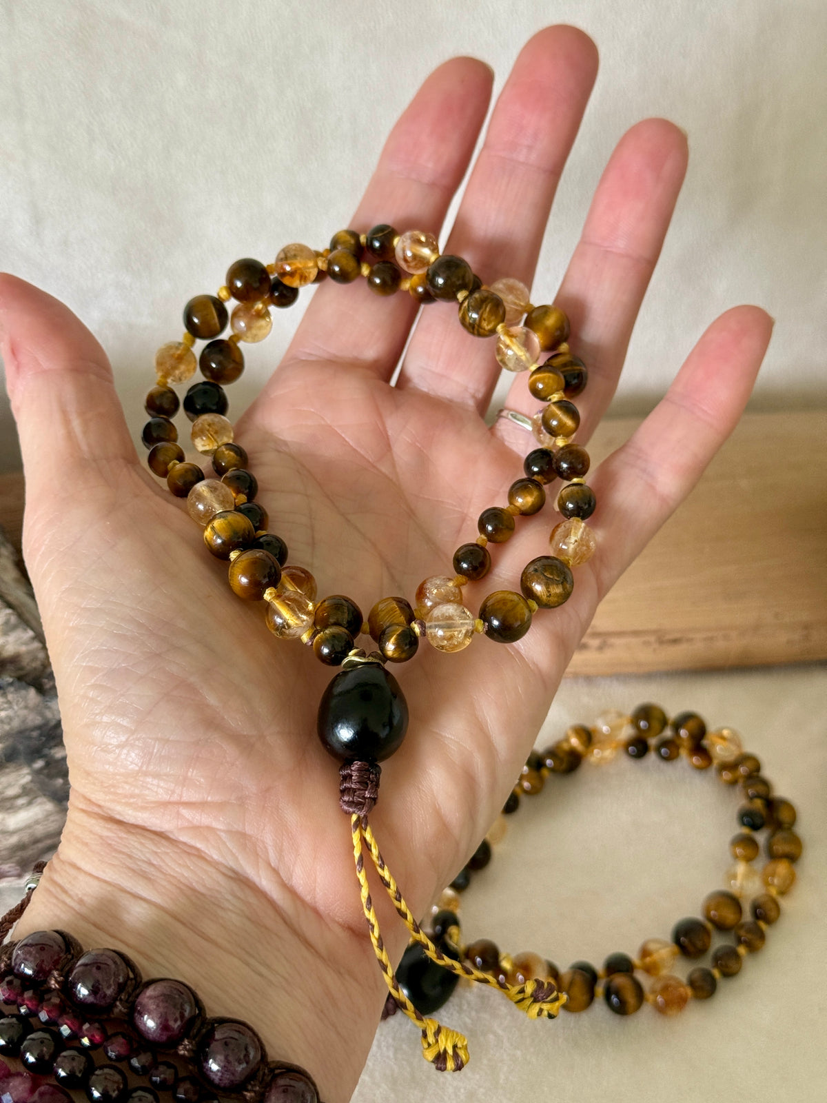 Handmade Box Breathing Mala with tiger's eye and citrine, featuring a natural soap-berry seed meru, designed for box breathing, meditation, and a return to your own center.