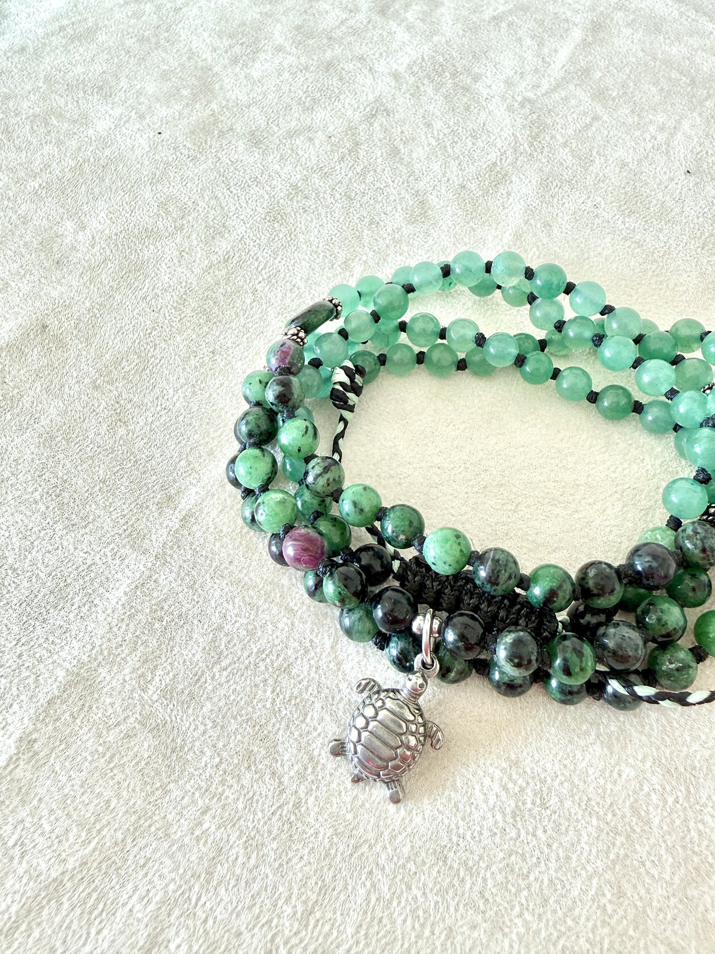 Handmade green mala bracelet with natural 6 mm gemstones, stainless steel turtle charm, adjustable macramé closure, and 108 bead mala necklace design for yoga, meditation, gentle growth, protection, and spiritual transformation. 