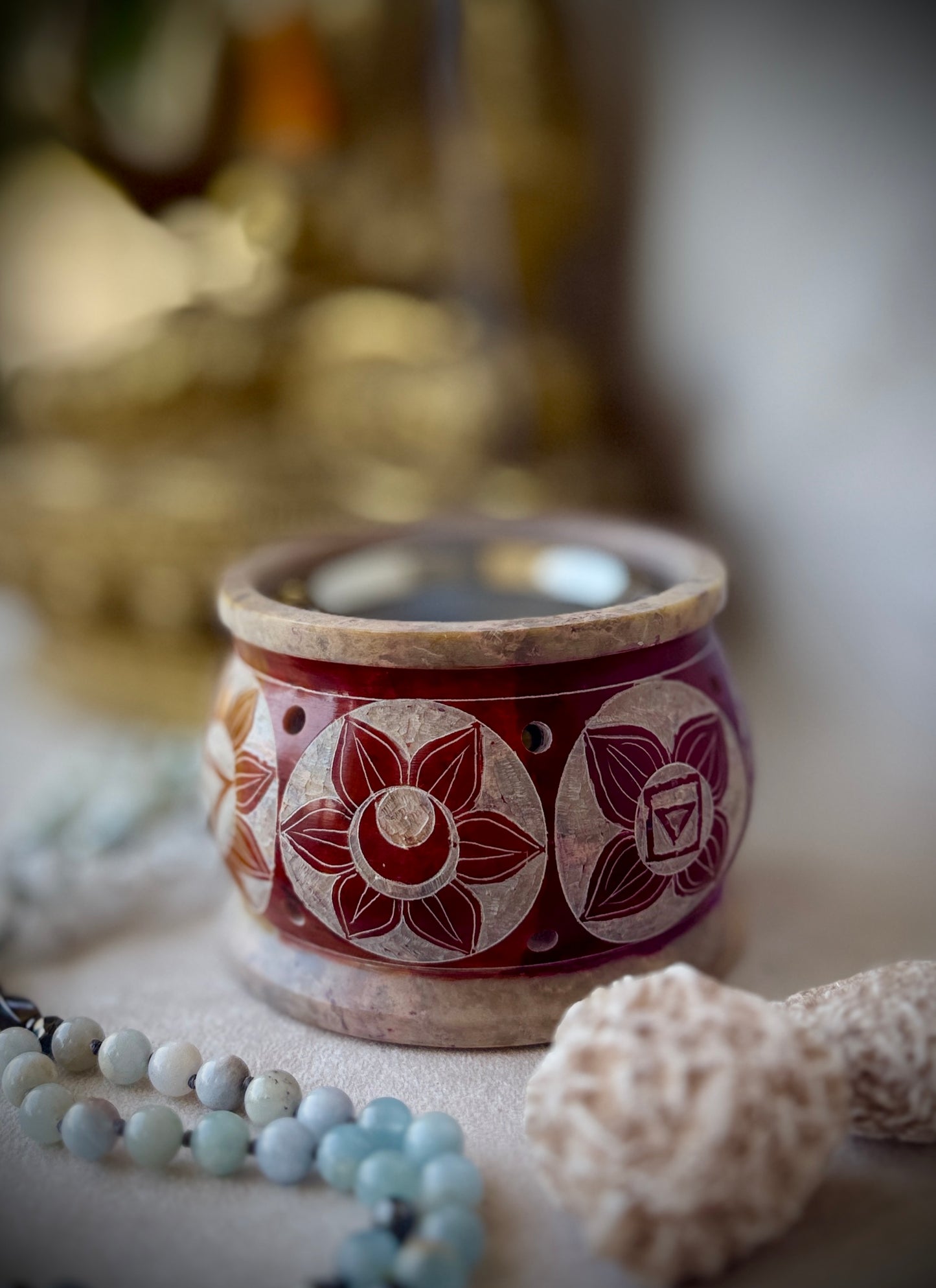 Incense and resin burner on meditation altar with crystals and candles