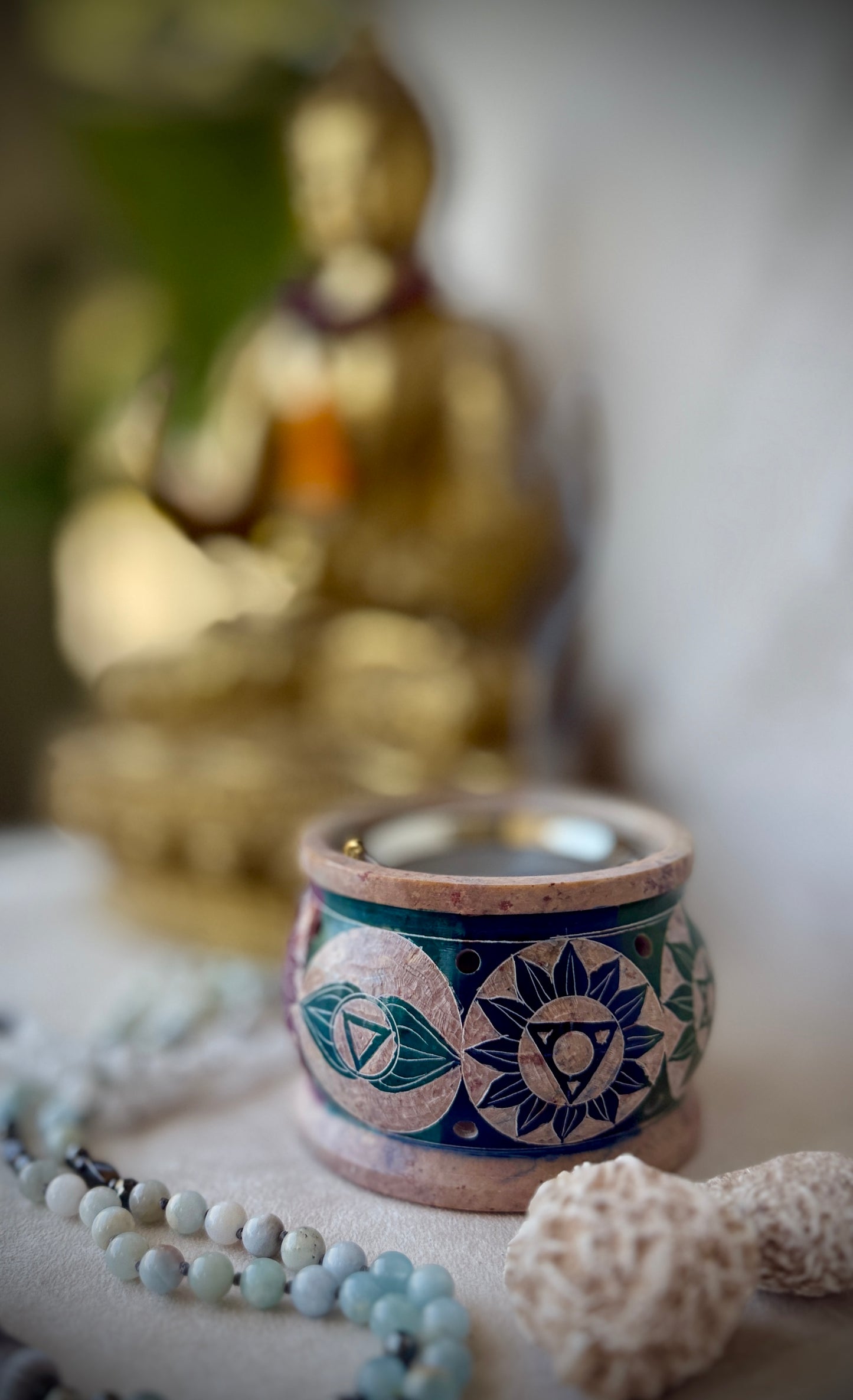 Incense and resin burner on meditation altar with crystals and candles