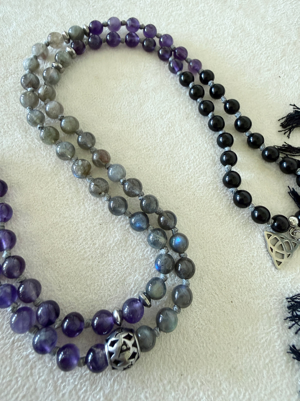 Labradorite beads on the Shadow Work Mala with black tassel, Triquetra charm and Om Mani Padme Hum mantra bead