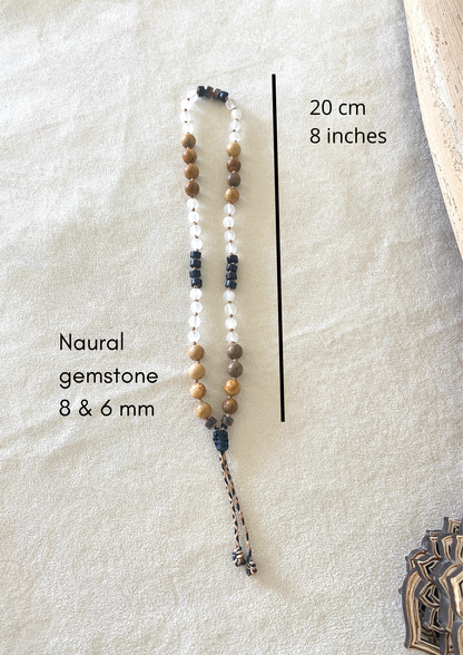 Measures of grounding natural gemstone obsidian, selenite, jasper breathing mala bracelet with groups of four beads to guide inhale, hold, exhale, and hold during breathwork practice. 