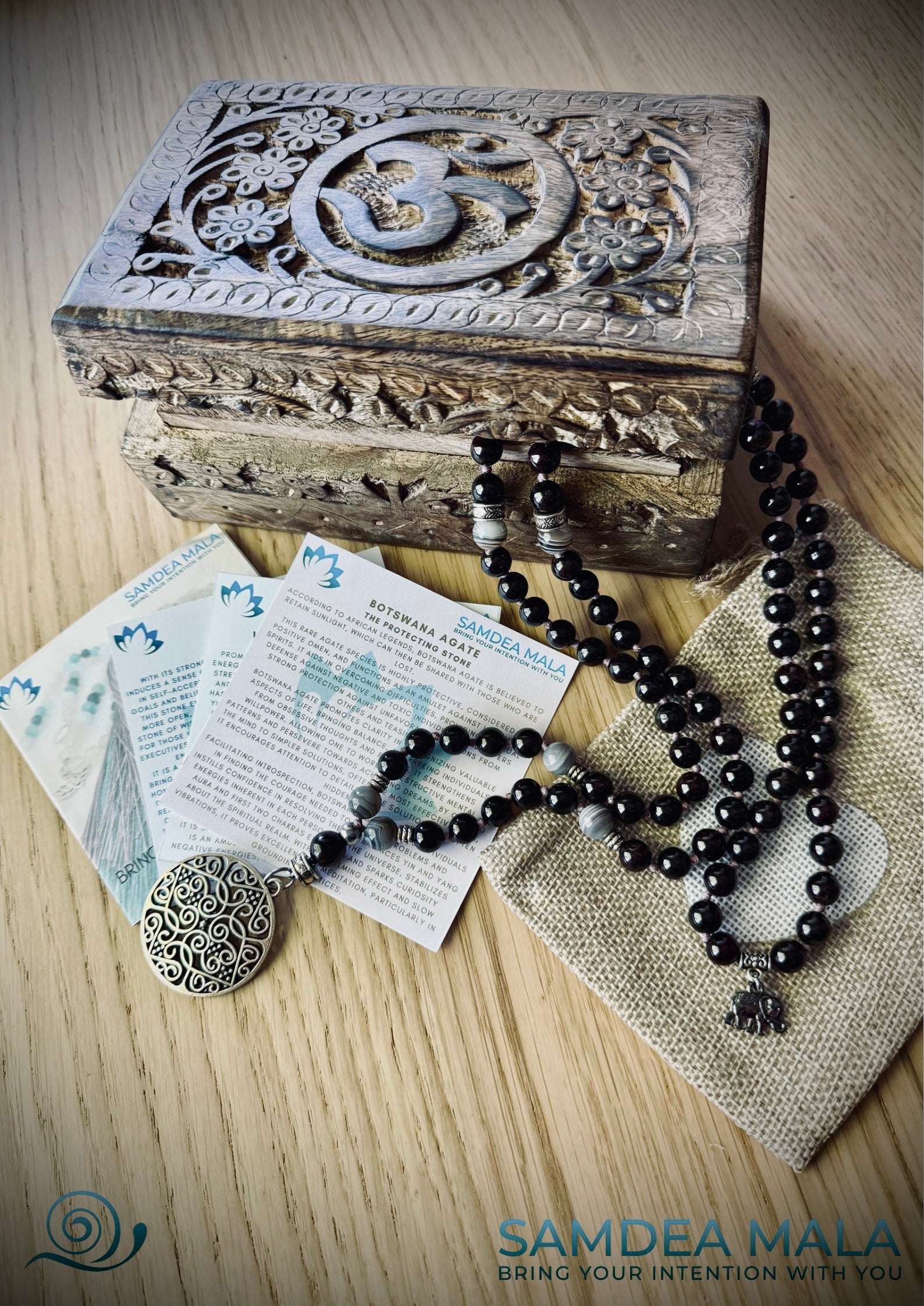 Packaging Samdea Mala Guru Mala beads with carved wood spiritual jewelry box