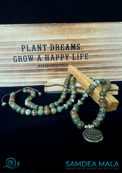 Featuring  Forest Rhyolite jasper wrap bracelet with lotus charm, green and brown forest rhyolite for purity and transformation. 