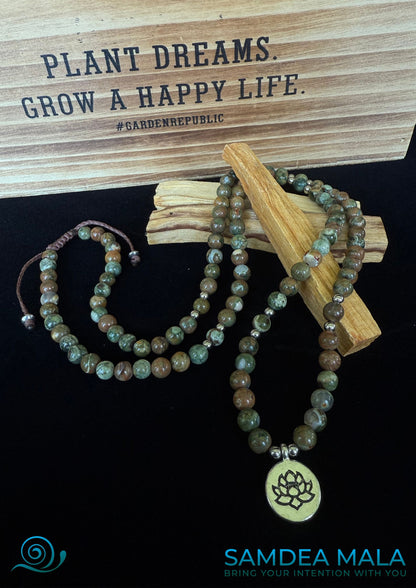 Full view of Rhyolite jasper wrap bracelet with lotus charm, green and brown forest rhyolite for purity and transformation. 