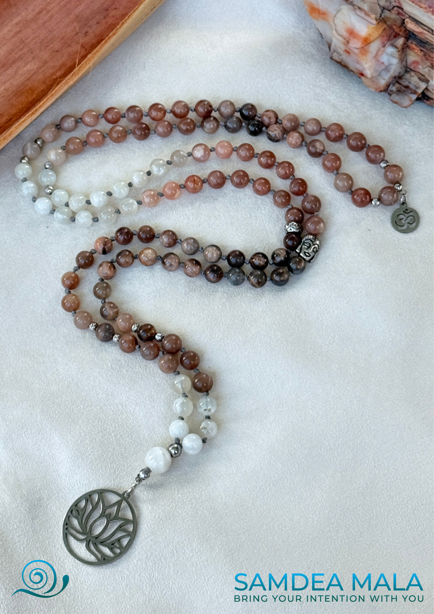 Moonstone Mala with Buddha – Hand-Knotted Feminine Energy Mala | Intuition Mala with Lotus Pendant | 108 Beads | Self-Connection & Lunar Magic. Hand knotted, handcrafted in US. 108 moonstone beads in soft pink and gray hues, Spiritual jewelry for intuition, lunar energy, and inner self-connection. Moonstone mala necklace.