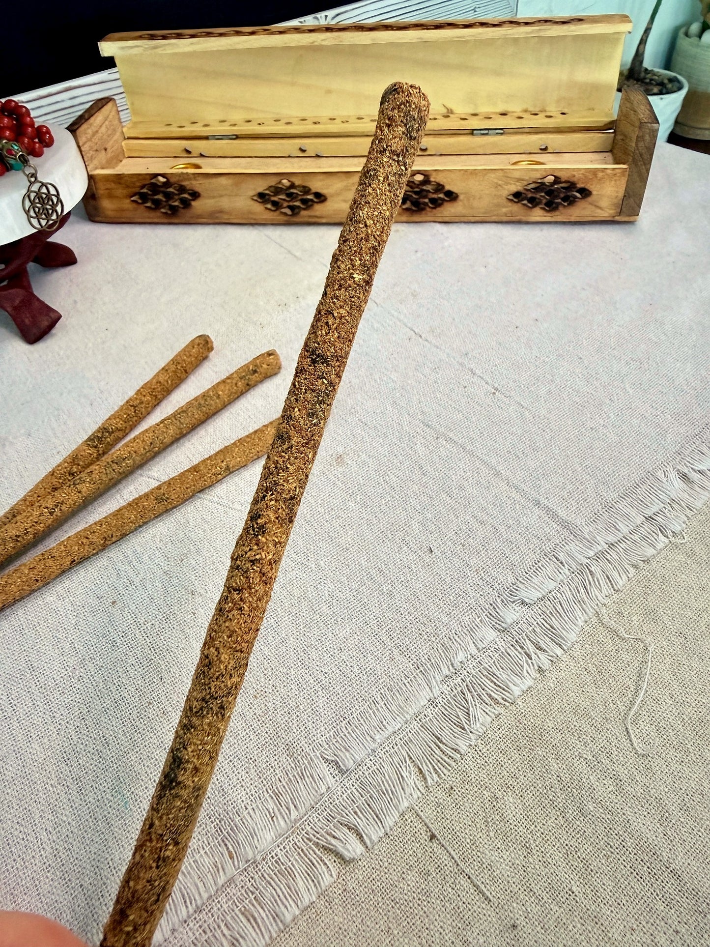 one, detail of masala incense Plant-based artisan hand-rolled in India incense stick, natural non-toxic ingredients. Resin rolled incense stick texture detail showing herbal blend and artisan hand rolled Nag Champa tradition