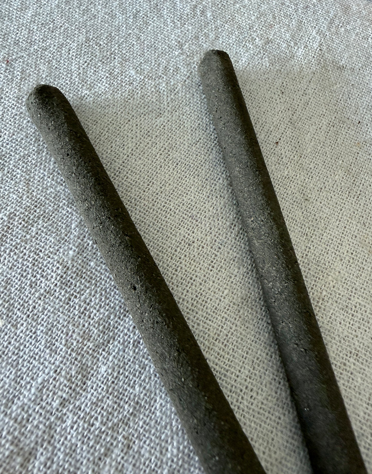 close up of Natural hand rolled non toxic incense sticks made with herbs and resins for mental clarity and energetic cleansing