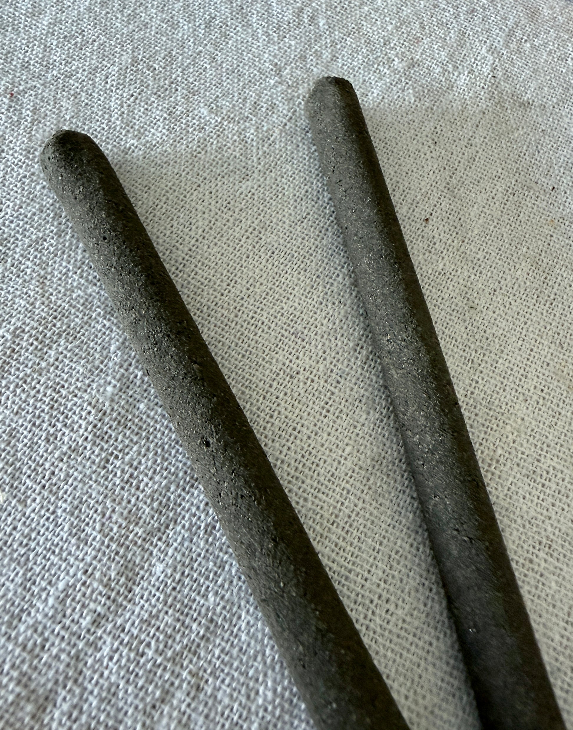 close up of Natural hand rolled non toxic incense sticks made with herbs and resins for mental clarity and energetic cleansing