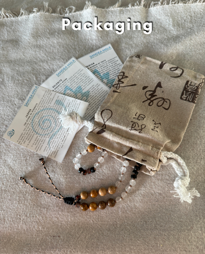 Packaging of natural gemstone Breath Mala in natural gemstones with stone descriptions and natural cotton pouch, designed to support mindful breathing and easy to carry with you every day.