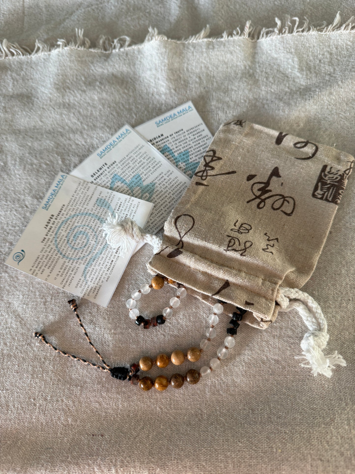 Packaging of natural gemstone Breath Mala in natural gemstones with stone descriptions and natural cotton pouch, designed to support mindful breathing and easy to carry with you every day.