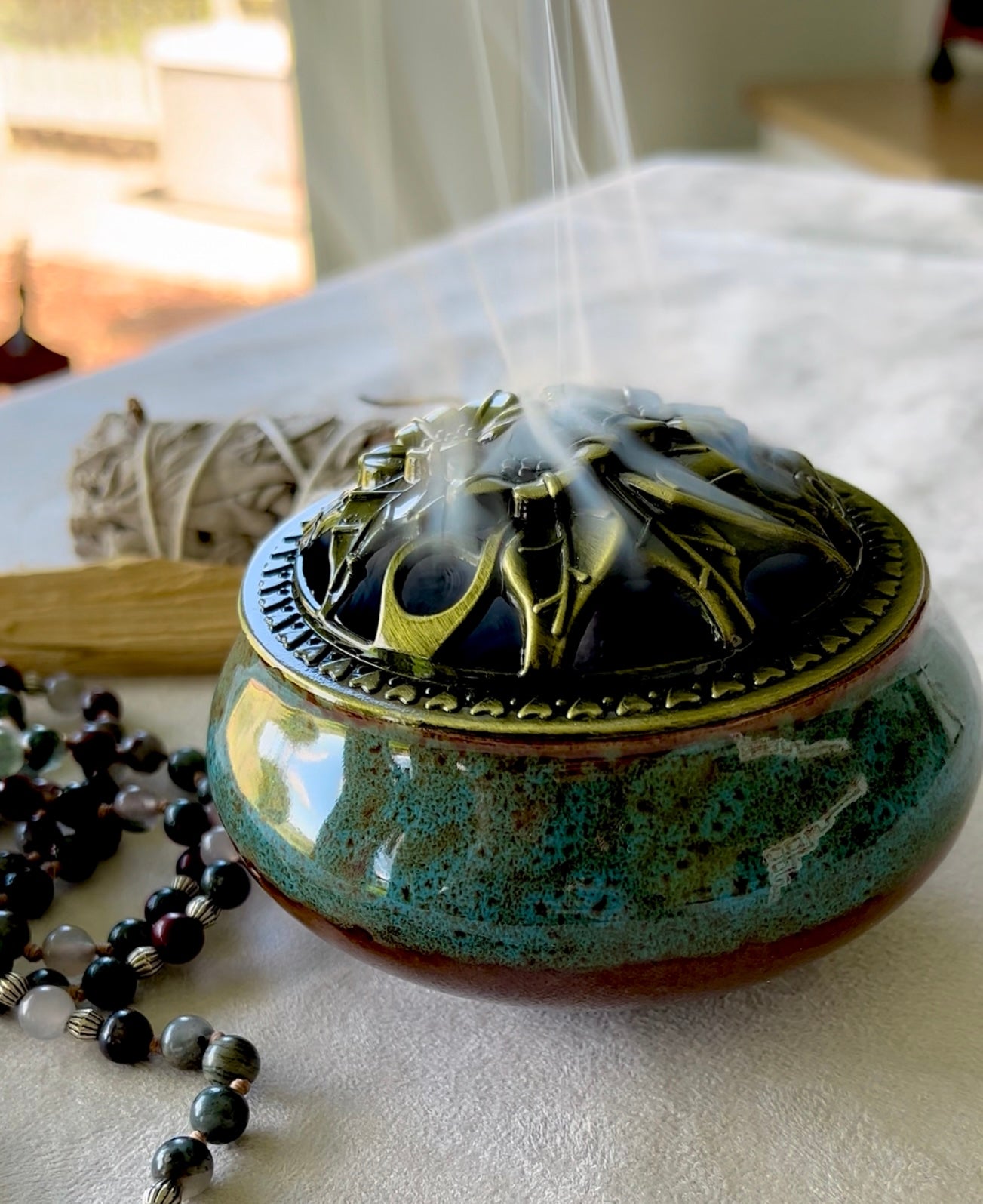blue ceramic vessel with a polished brass decorative lid, 3 inches diameter, shown as a home decor accessory.