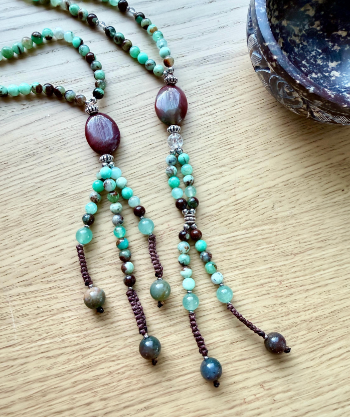 SGI Nichiren juzu held in hand, showing natural chrysoprase and agate beads