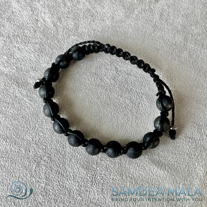 Meditation bracelet with Shungite. A black beaded Shamballa-style bracelet with a black cord.