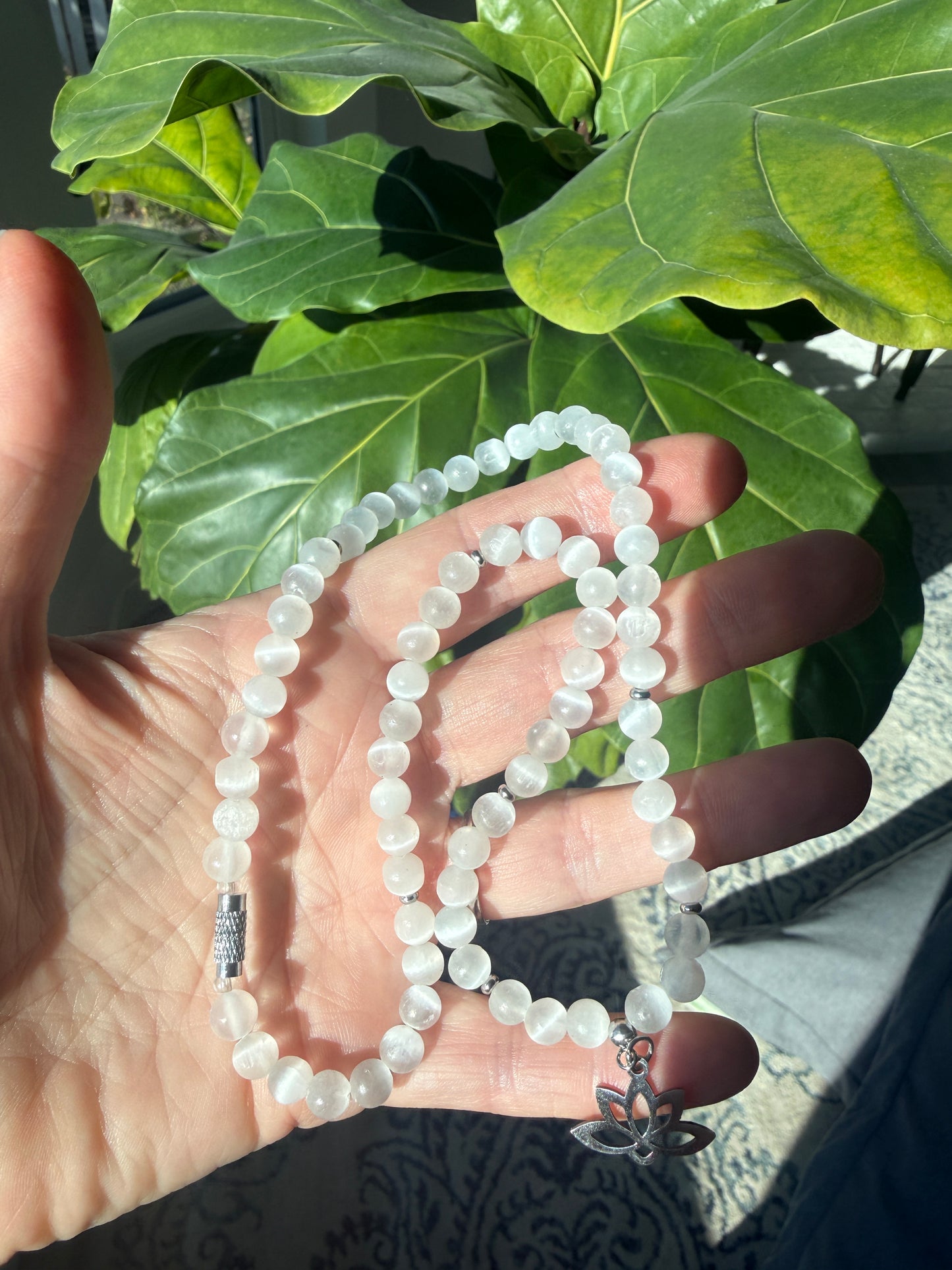 Spiritual selenite and lotus choker necklace on hand  - for purity and higher connection. Small lotus charm stainless steel.