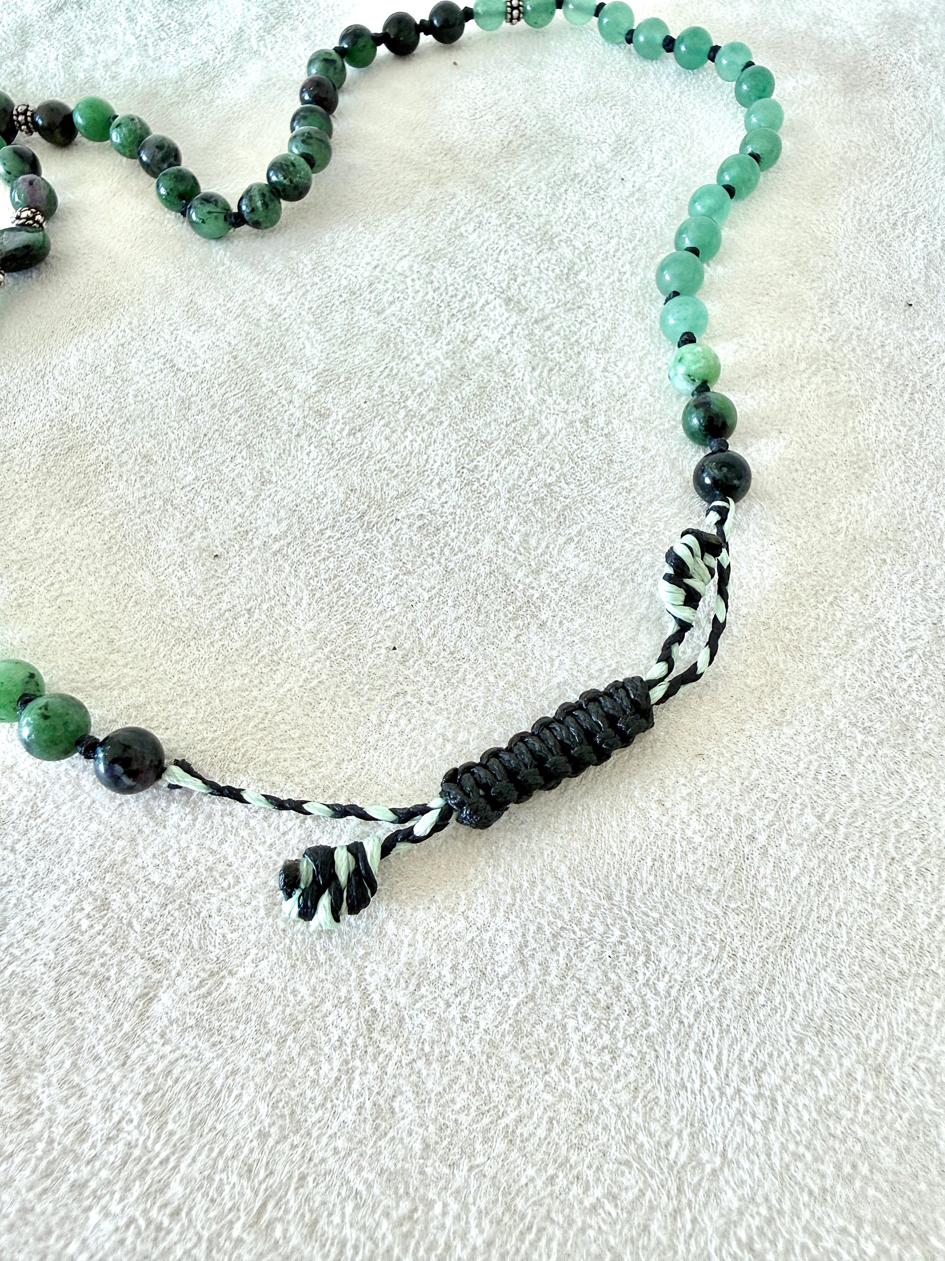 adjustable macramé closure, of a zoisite with ruby, aventurine  green mala bracelet with 100% natural gemstones, stainless steel turtle charm and 108 bead mala necklace design for yoga, meditation, gentle growth, protection, and spiritual transformation. 