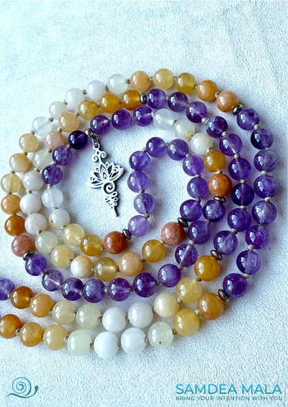 Close-up: polished amethyst and topaz-hued jade beads, waxed cord knots visible - sagittarius birthstoned - unalome and lotus charm