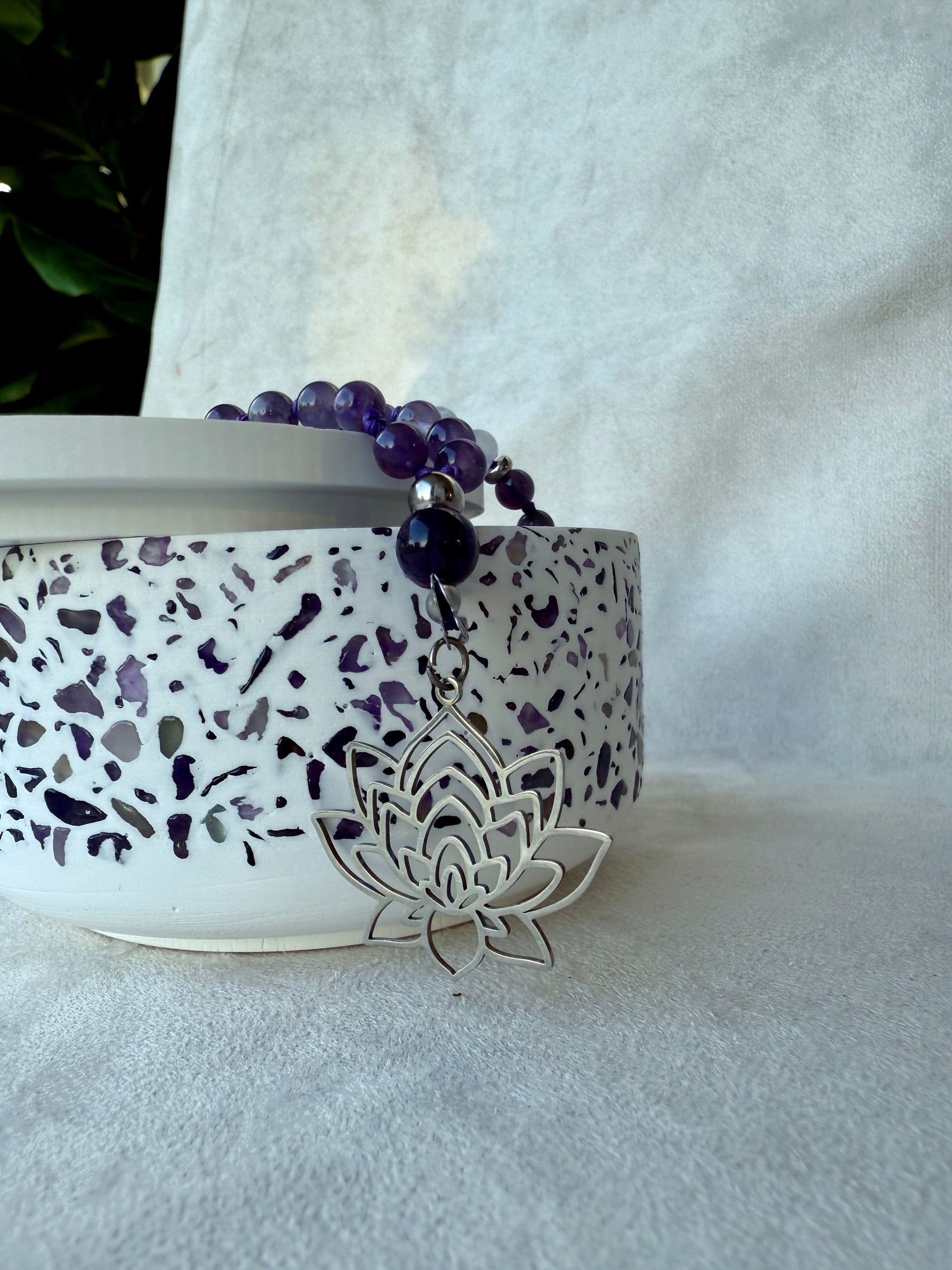 Detail: guru bead and tassel on amethyst white jade meditation mala