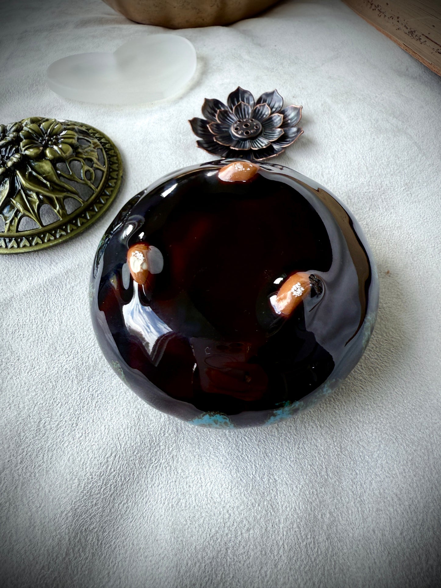 bottom of deep blue ceramic vessel with a polished brass decorative lid, 3 inches diameter, shown as a home decor accessory.