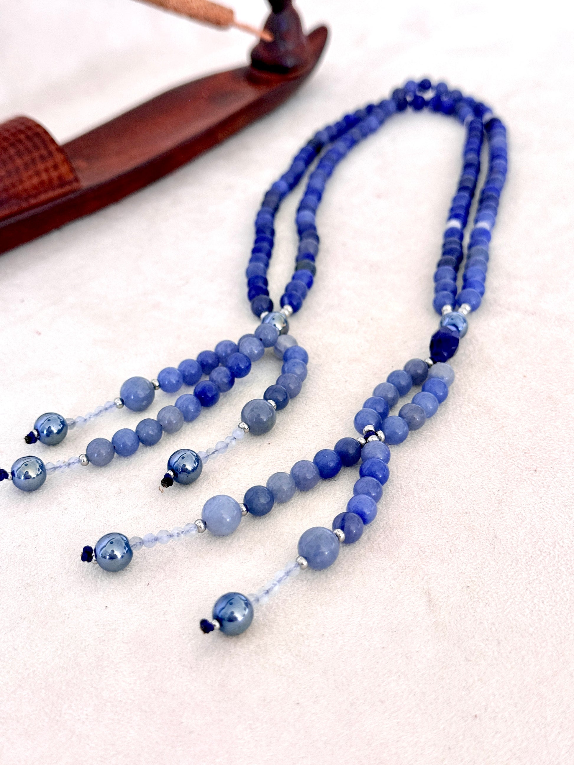 full view of of blue SGI Buddhist prayer, handmade Japanese Nichiren juzu for Daimoku chanting, Nam Myoho Renge Kyo meditation, with blue aventurine, Burmese white jade Bodhisattva, aqua aura accents, and lapis lazuli details.