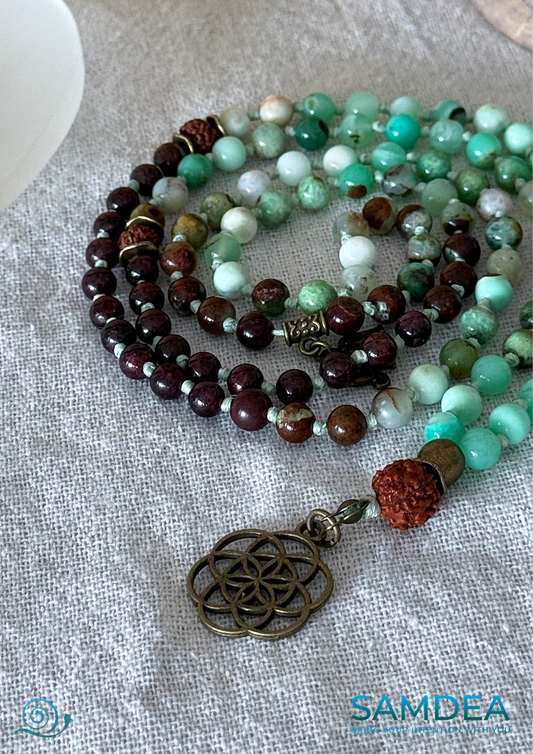 close-up of Samdea Mala chrysoprase garnet rudraksha mala necklace with Seed of Life pendant - Hand knotted 108 bead mala for meditation in chrysoprase garnet and rudraksha