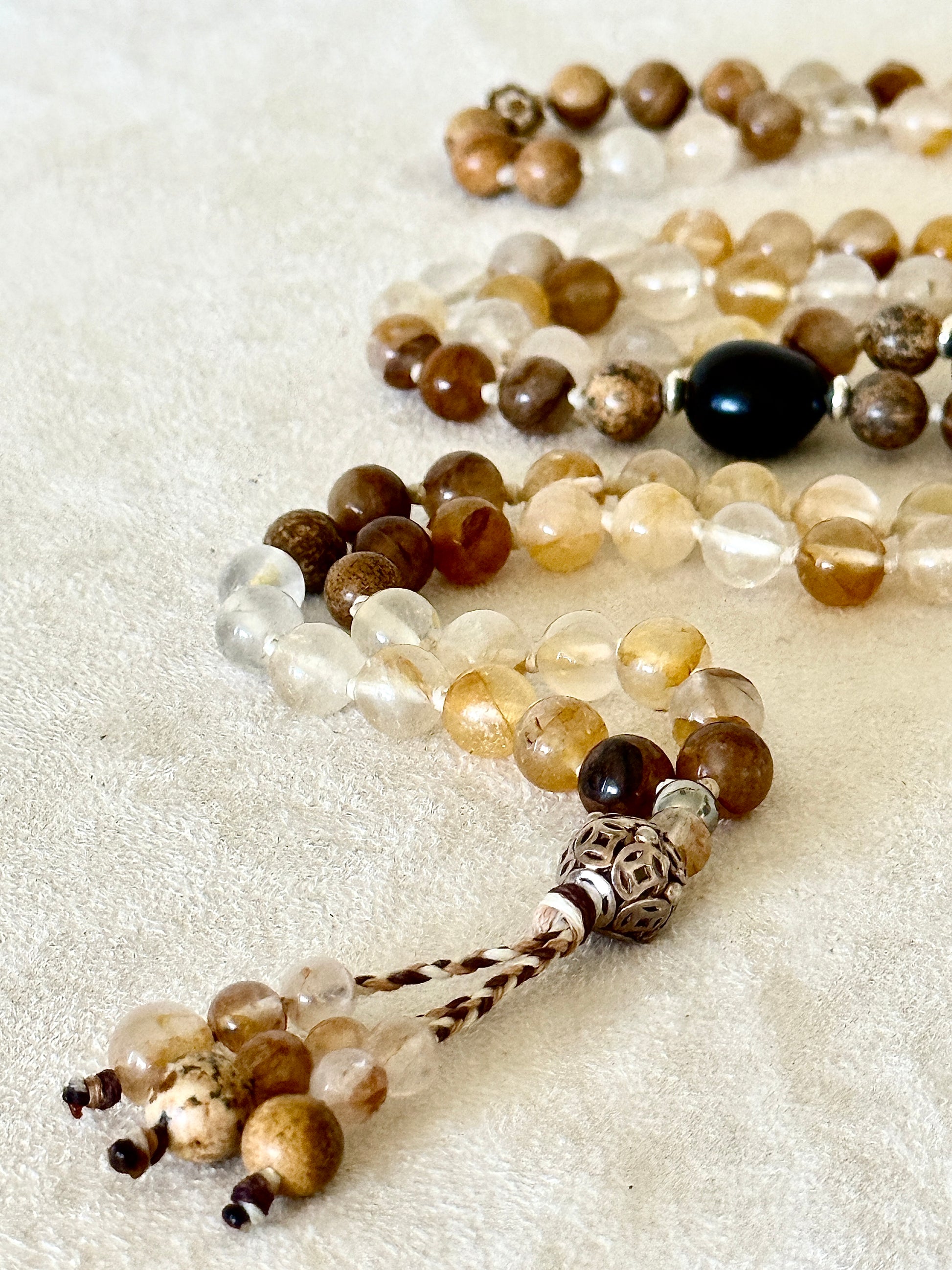 detail of One-of-a-kind 108 bead hematoid quartz and sand jasper mala with soapberry seeds and sterling silver details, handmade by Samdea