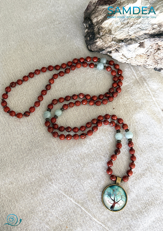 full view of a red meditation mala, first chakra japamala for mindfulness. Mala Necklace – Red Jasper & Aquamarine, 108 Faceted Prayer Beads