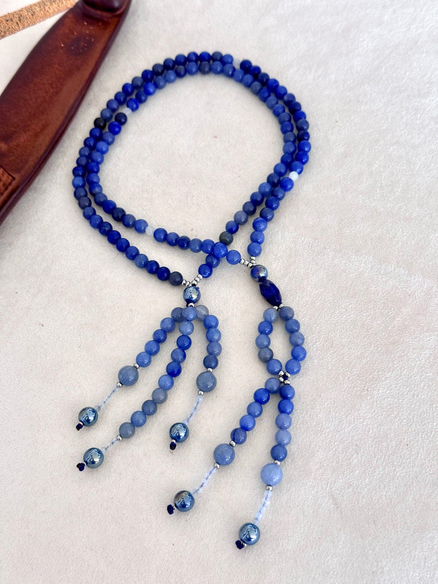 full view of of blue SGI Buddhist prayer, handmade Japanese Nichiren juzu for Daimoku chanting, Nam Myoho Renge Kyo meditation, with blue aventurine, Burmese white jade Bodhisattva, aqua aura accents, and lapis lazuli details.