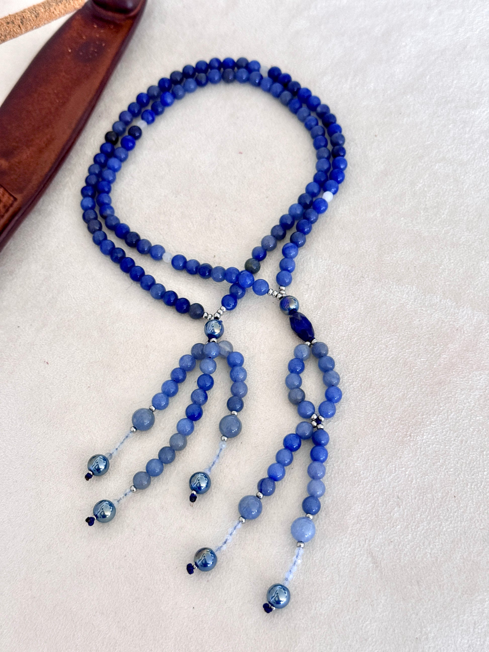 full view of of blue SGI Buddhist prayer, handmade Japanese Nichiren juzu for Daimoku chanting, Nam Myoho Renge Kyo meditation, with blue aventurine, Burmese white jade Bodhisattva, aqua aura accents, and lapis lazuli details.