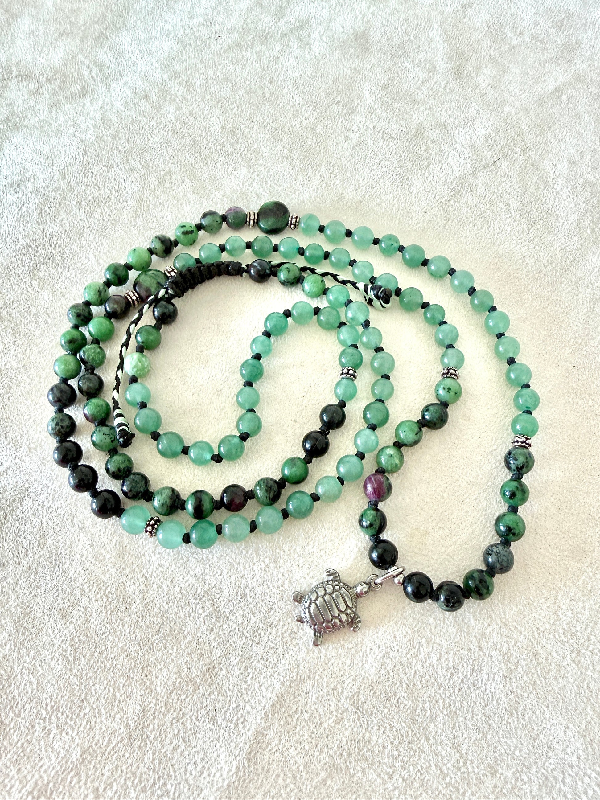 Measures of Handmade Zoisite with Ruby and Aventurine green mala bracelet with natural 6 mm gemstones, stainless steel turtle charm, adjustable macramé closure, and 108 bead mala necklace design for yoga, meditation, gentle growth, protection, and spiritual transformation. Samdea Mala