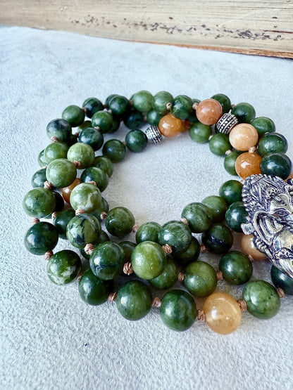 Close-up of green jade beads showing natural marbling on hand-knotted cord