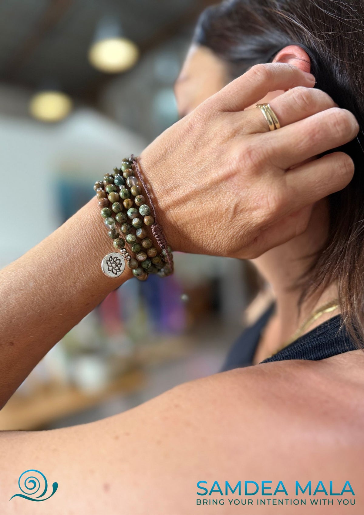Example of a Samdea mala bracelet with a lotus charm worn wrapped multiple times around the wrist, thanks to the adjustable macramé closure
