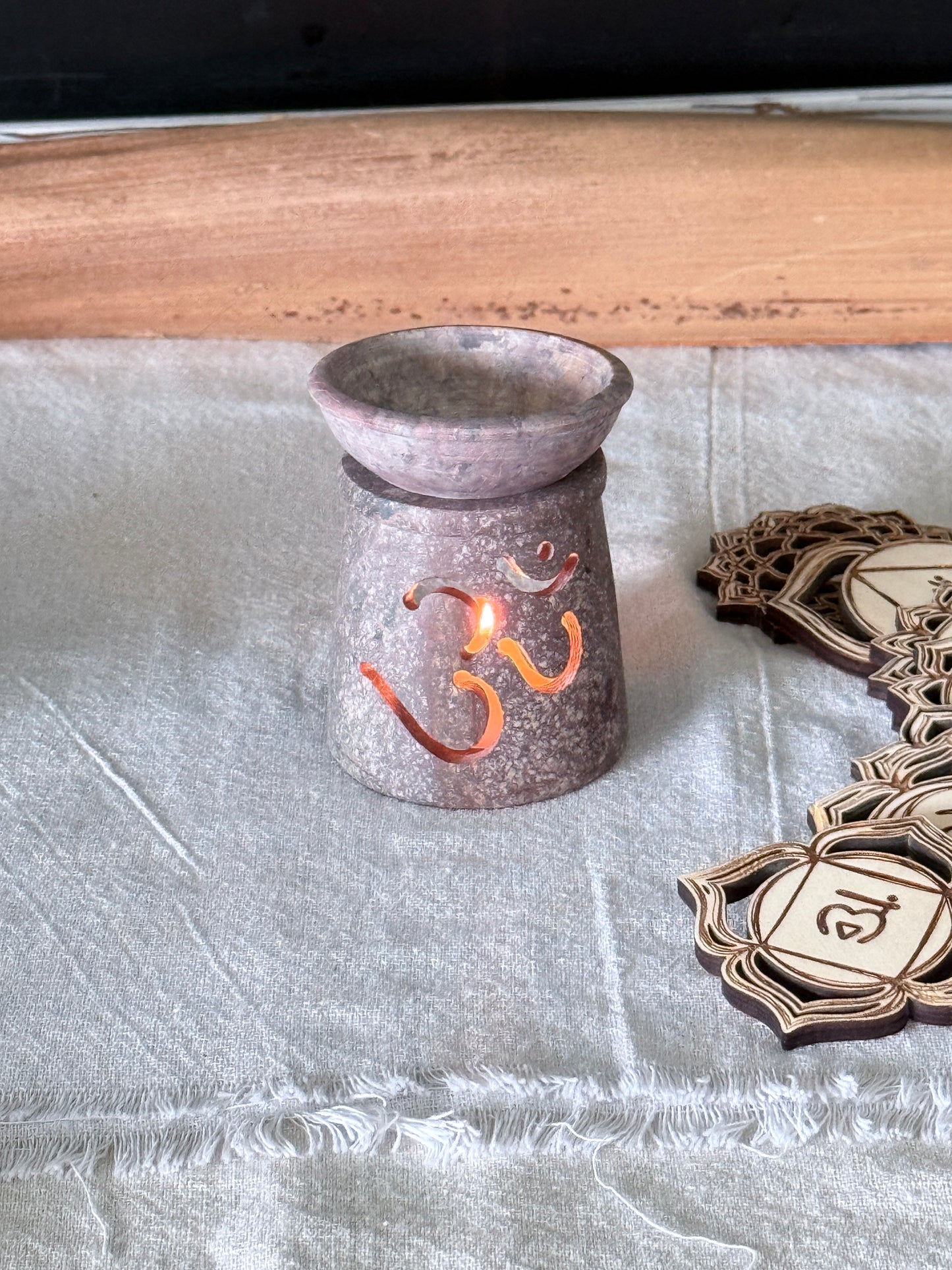 om_soapstone_incense_burner Meditation corner styled with 7 chakras and soapstone incense burner, serene home altar OM