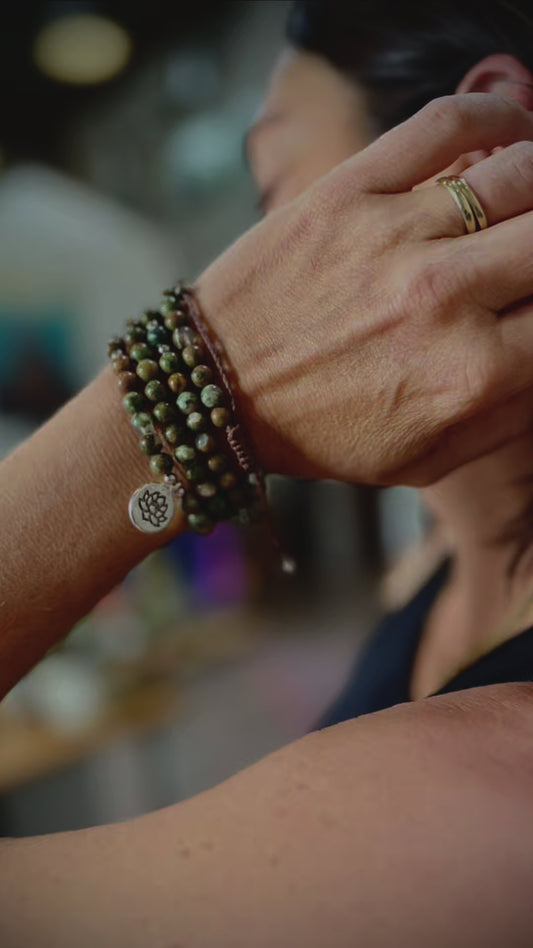 Video wrap bracelet – Rhyolite jasper wrap bracelet with lotus charm, green and brown forest rhyolite for purity and transformation. Jewelry for grounding and spiritual reflection