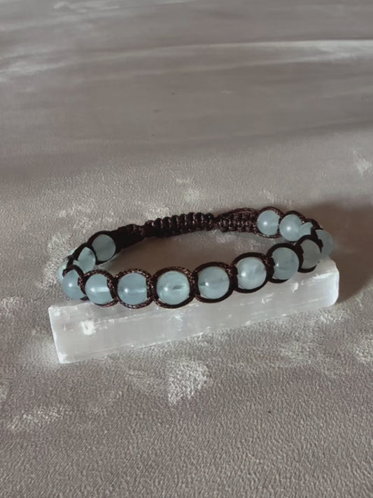 Video preview of Tibetan Tamashii- style Bracelet in Aquamarine - meditation bracelet for intention of balance and peace, mindful living. Clear blue beads Shamballa bracelet with spiritual natural gemstones.