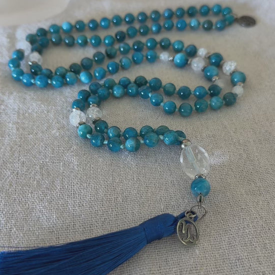 video preview of handmade mala in natural apatite for self confidence and appetite regulation - custom mala beads, OM charm, blue teal spiritual mala with tassel - prayer beads for meditation and mindfulness