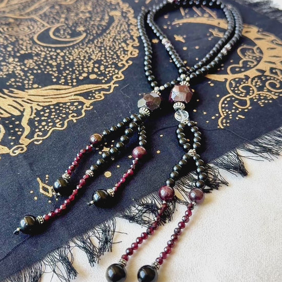 video preview of Obsidian and garnet juzu with clear quartz – a talisman of sacred protection, clarity, and devotion for your daily spiritual journey.