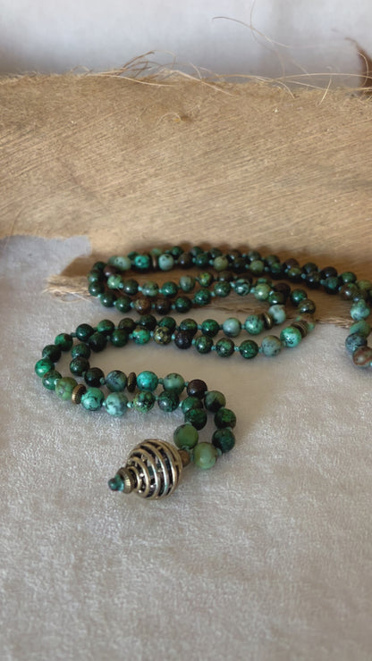 video of hand-knotted Turquoise Jasper mala beads showing stone texture and calming green-blue tones